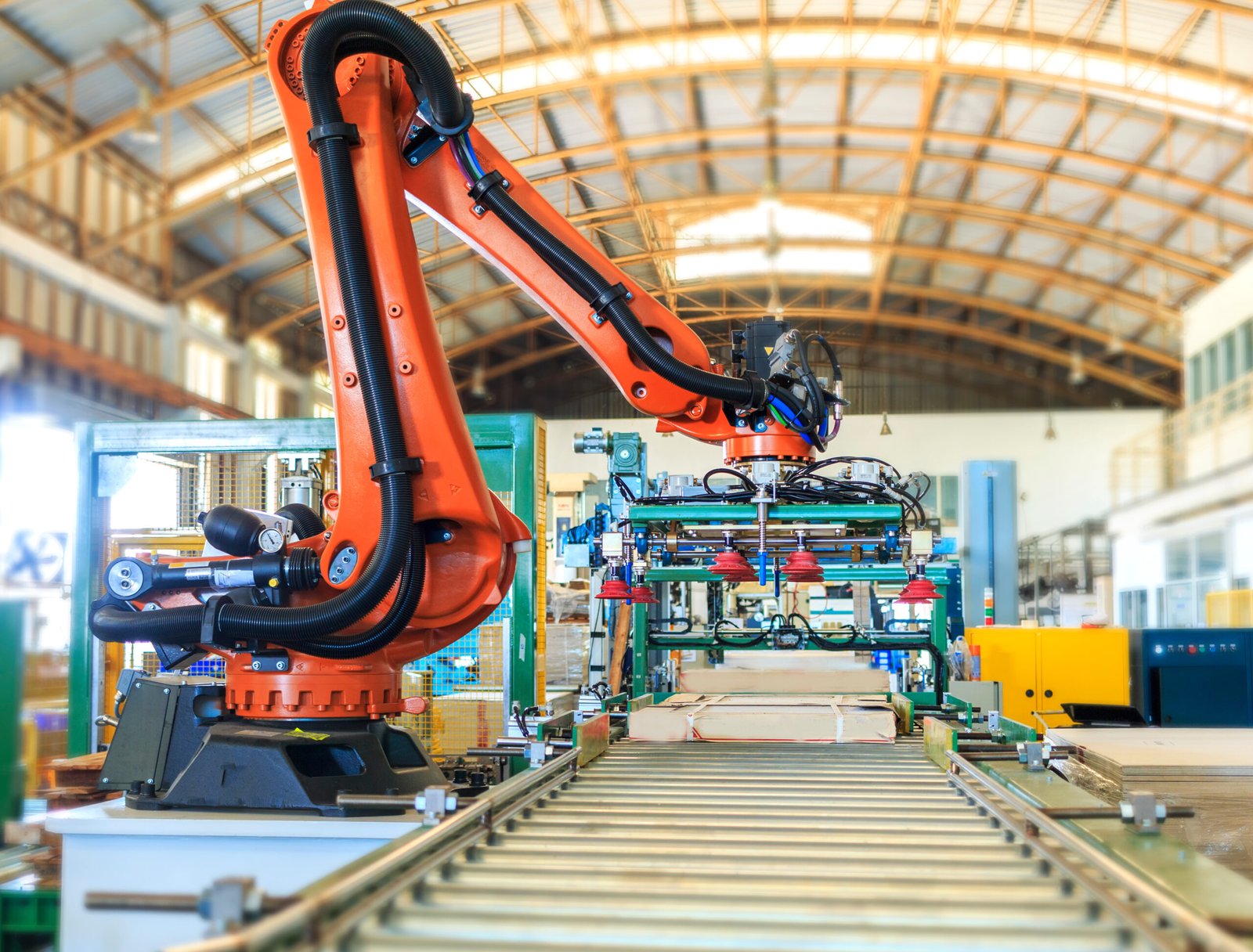 Industrial robot operating in a smart warehouse system, representing Factory 4.0 and advanced Materials & Specialty Manufacturing Automation.