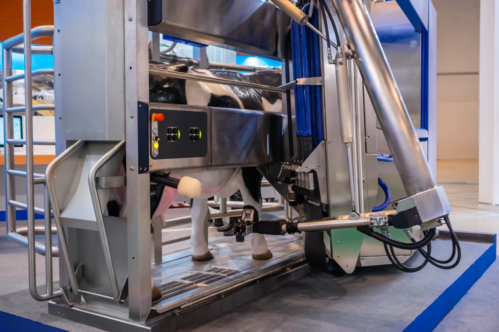 Automatic milking robotic arm machine showcased at a cattle dairy farm trade show, highlighting advanced Livestock & Dairy Farm Robotics technology.