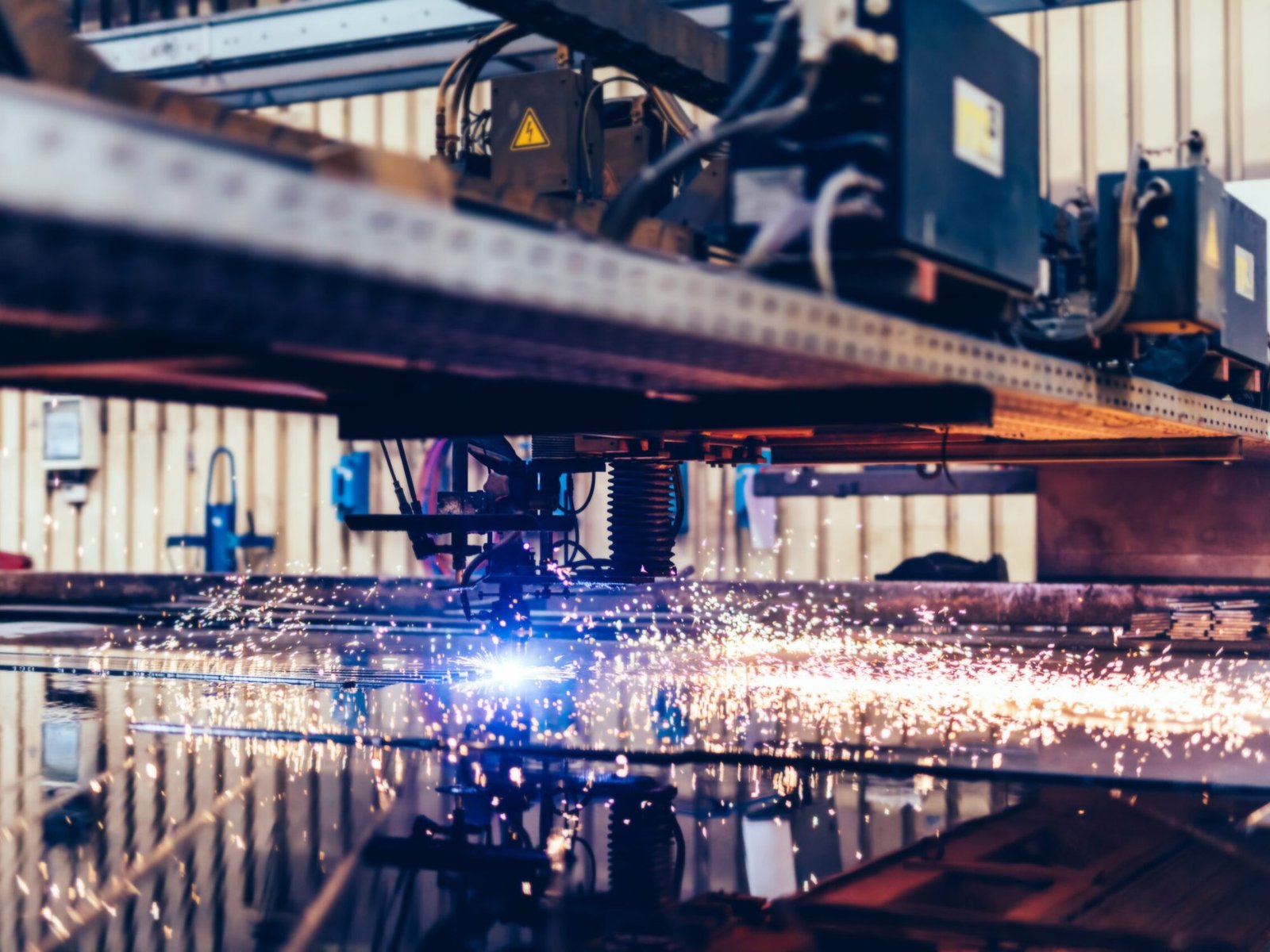Flame cutting process with steel profiling machine in a factory, Shipyard