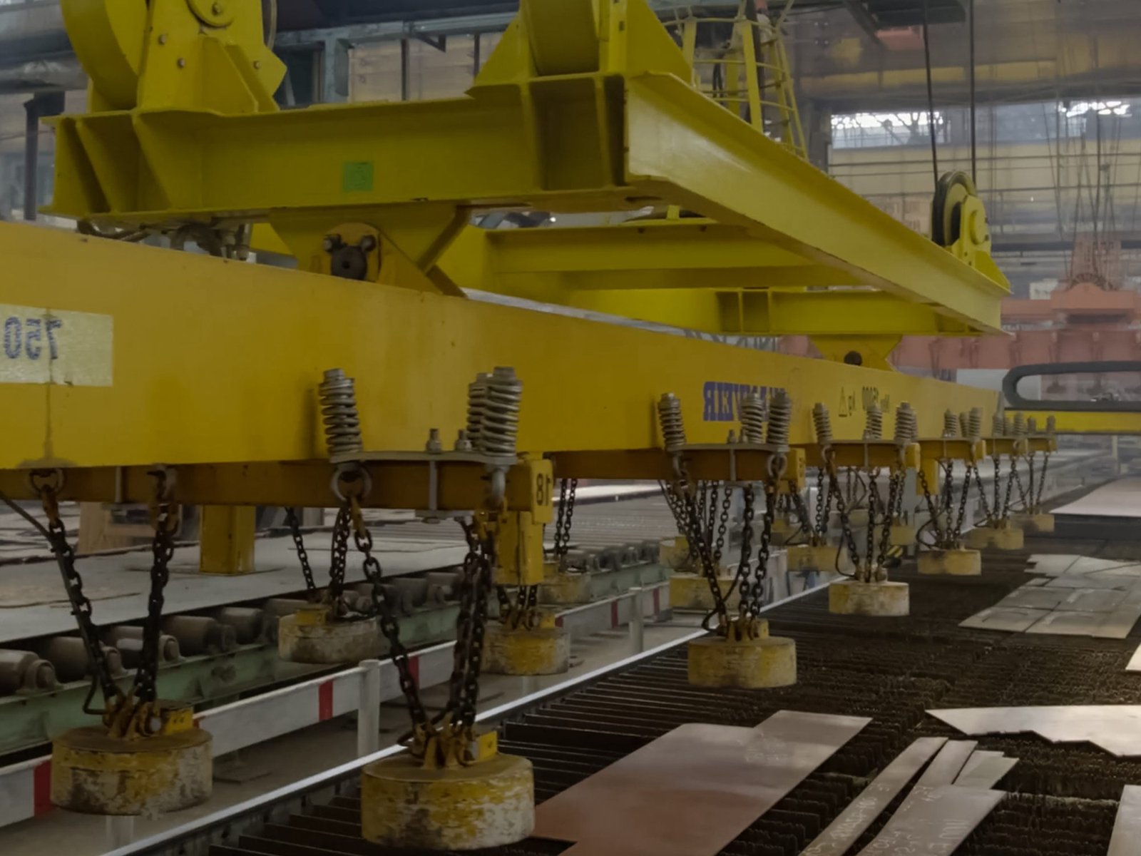 Magnetic parts moving in a shipyard with shipbuilding robotics integration for efficient workplace mechanization and automation.