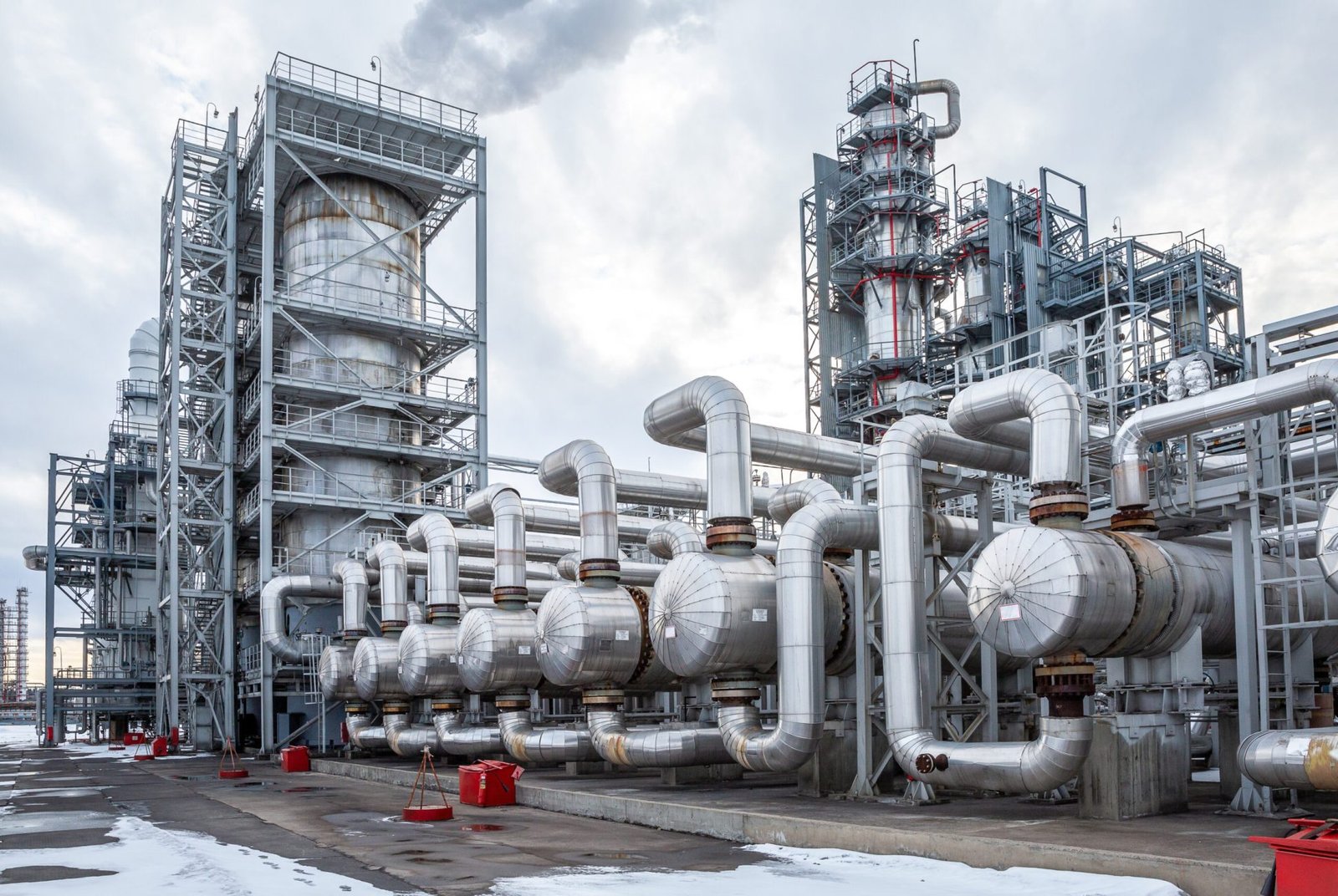 Large heat exchanger in an oil refinery during daylight, showcasing industrial equipment used in Oil and Gas Automation.